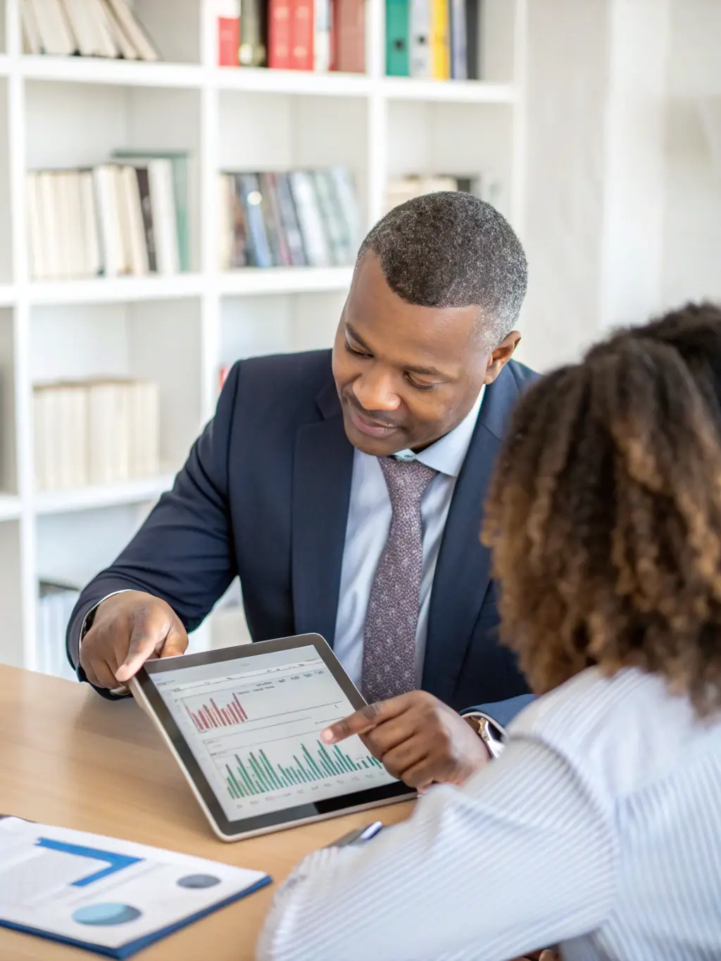 A professional financial advisor is shown explaining a recovery plan to a client in a modern office setting, emphasizing personalized service.